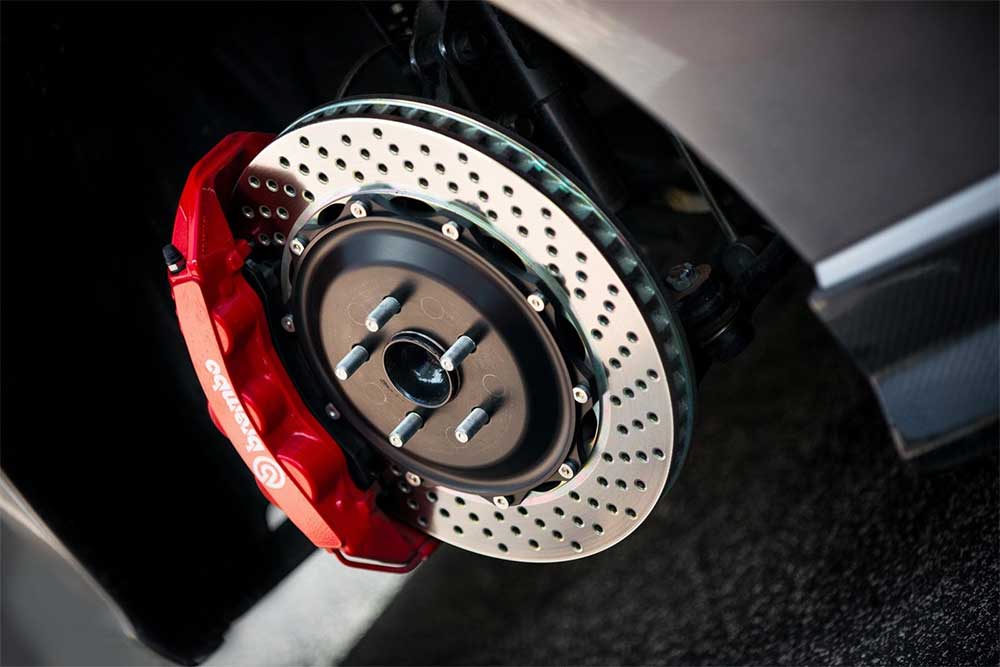 Close-up of a car brake disc and caliper being serviced